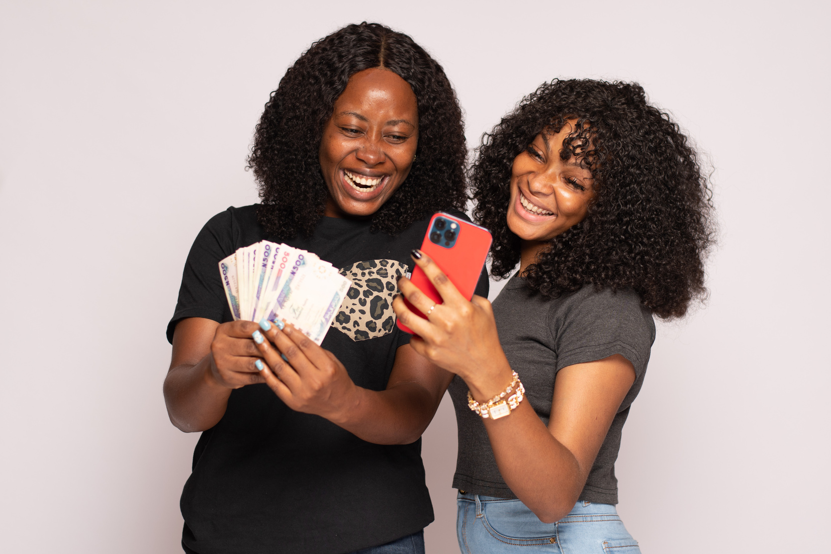 African Girls Feeling Excited Holding Money and Phone